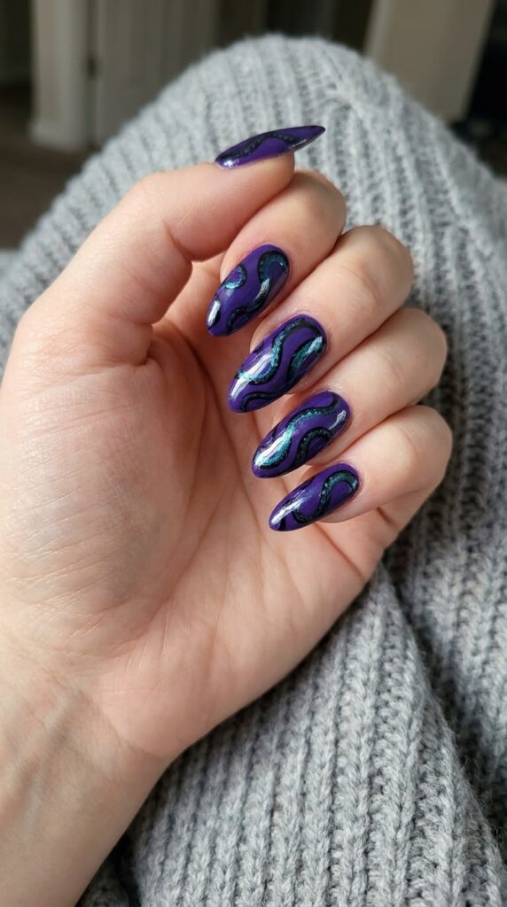Long almond violet nails with swirling black and metallic teal tentacles