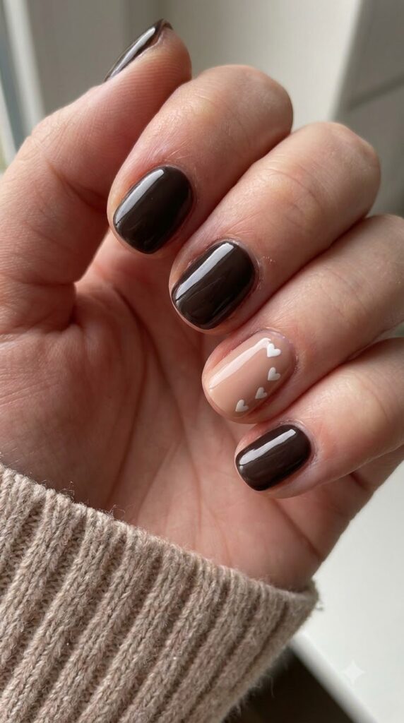 Short round dark espresso brown nails with white hearts near cuticle