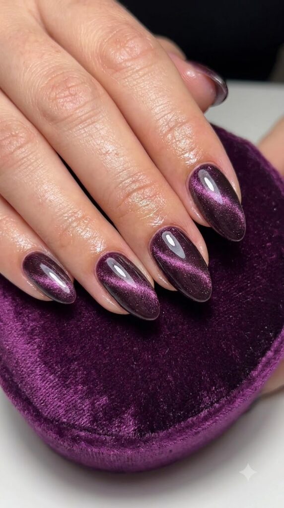 Almond deep mulberry purple magnetic cat-eye nails with 3D shimmer