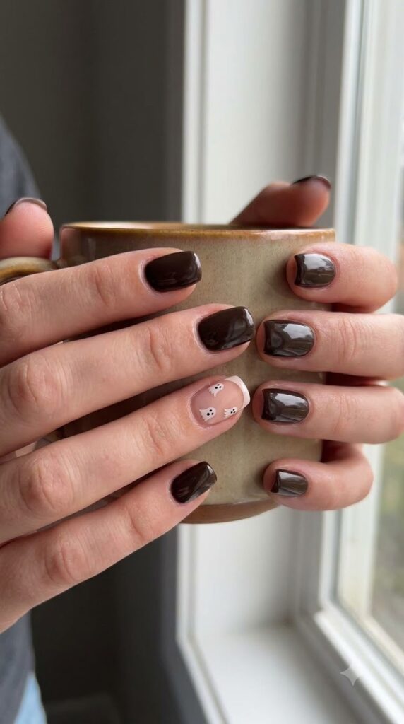 Short squoval espresso brown nails with a nude accent nail featuring ghost French tip