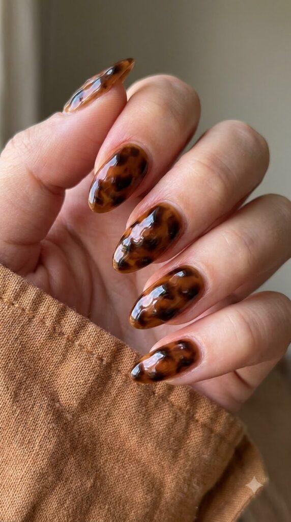 Medium almond amber jelly nails with dark brown black tortoiseshell art
