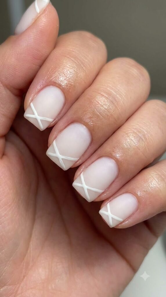 Short square milky white nails with fine white crisscross mummy wrap lines in matte