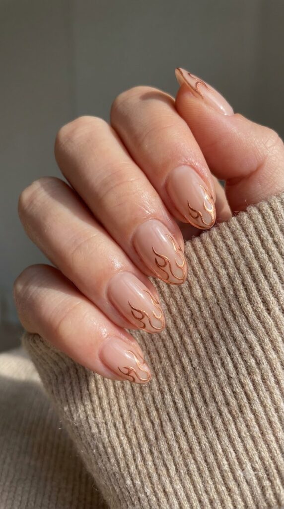 Short almond nude nails with ultra-thin metallic copper flame outline tips