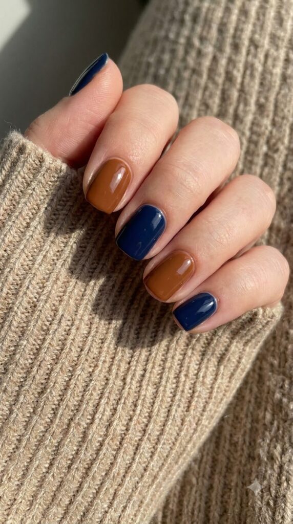 Short square nails alternating solid deep navy blue and warm cognac brown